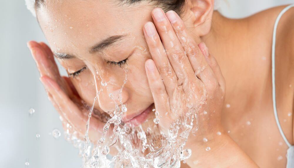 Young,Woman,Washing,Face,In,Room.