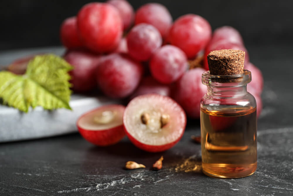 Bottle,Of,Natural,Grape,Seed,Oil,On,Dark,Table.,Organic